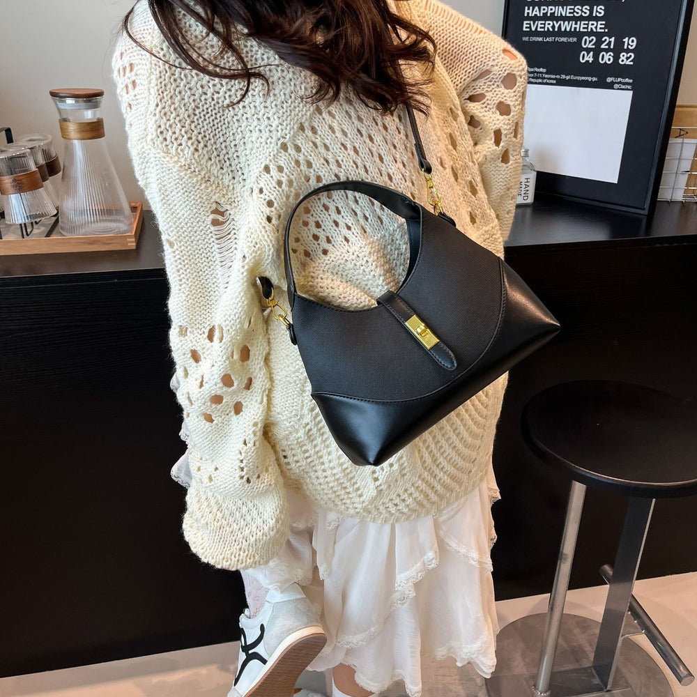 Black crescent hobo bag worn on the shoulder