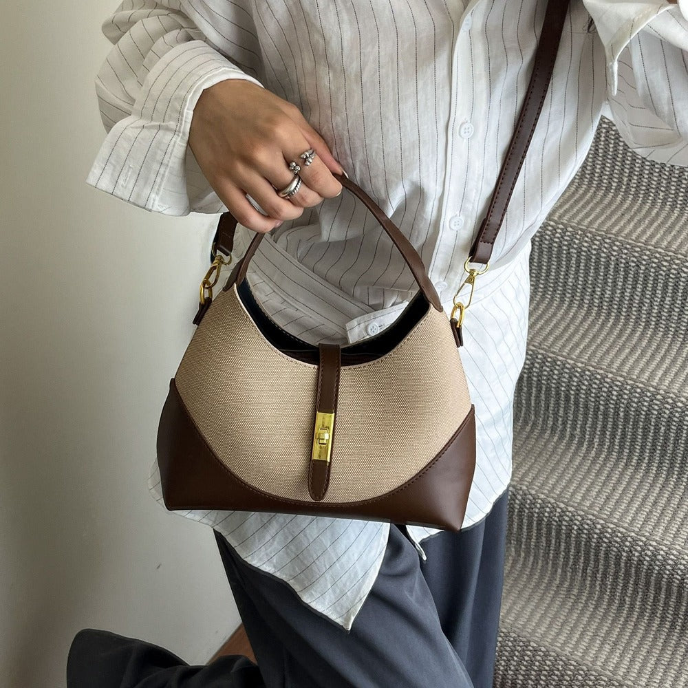 Woman carrying the two-tone hobo bag by its top handle