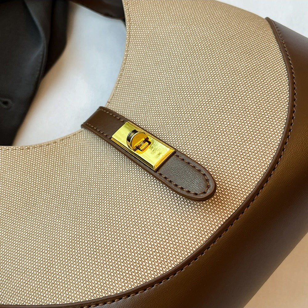 Close-up of the gold-tone turn-lock tab closure