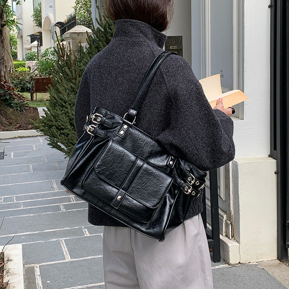Back view of the black tote bag worn on the shoulder