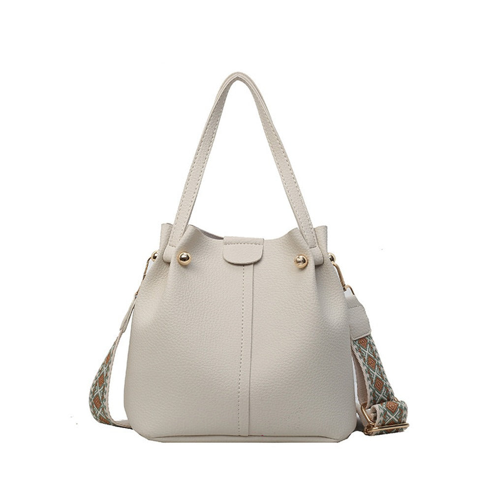 Bucket bag front view with top handles and wide strap