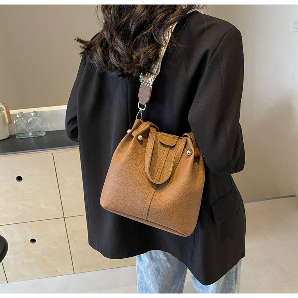 Brown bucket bag worn on the shoulder