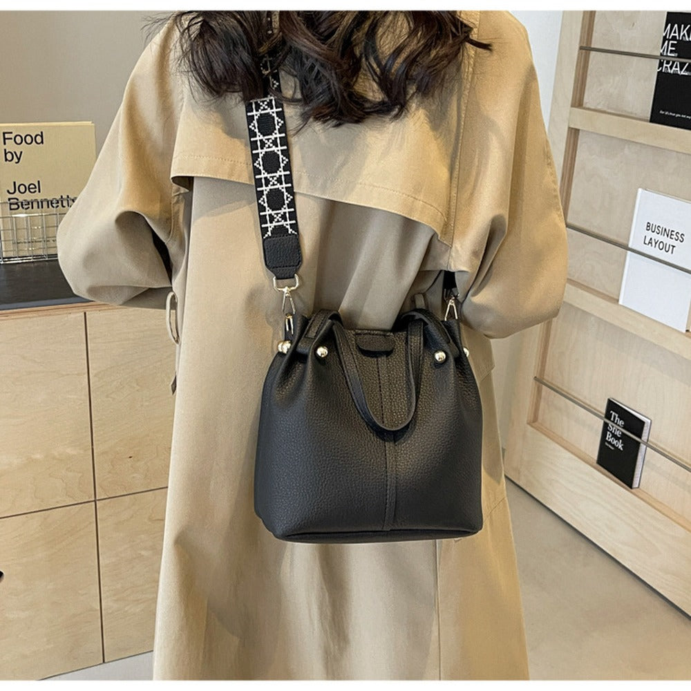 Black bucket bag worn crossbody