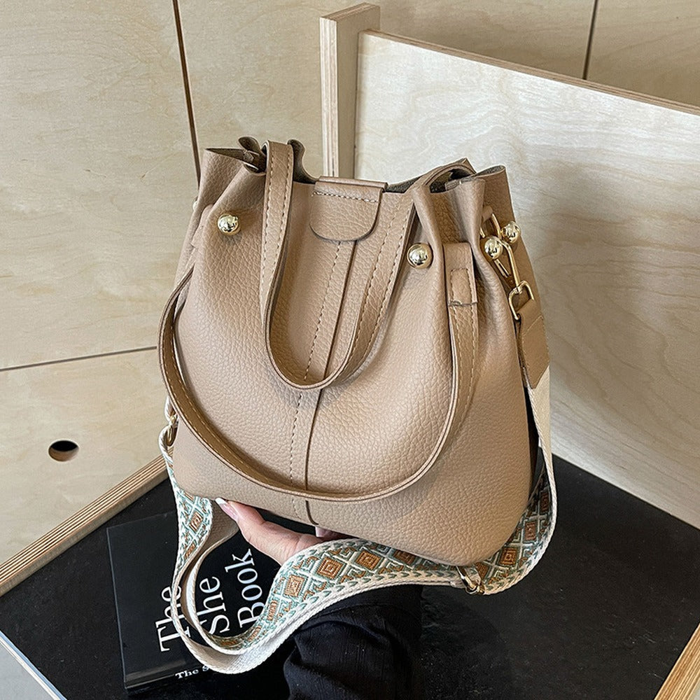Khaki bucket bag with top handles and wide crossbody strap