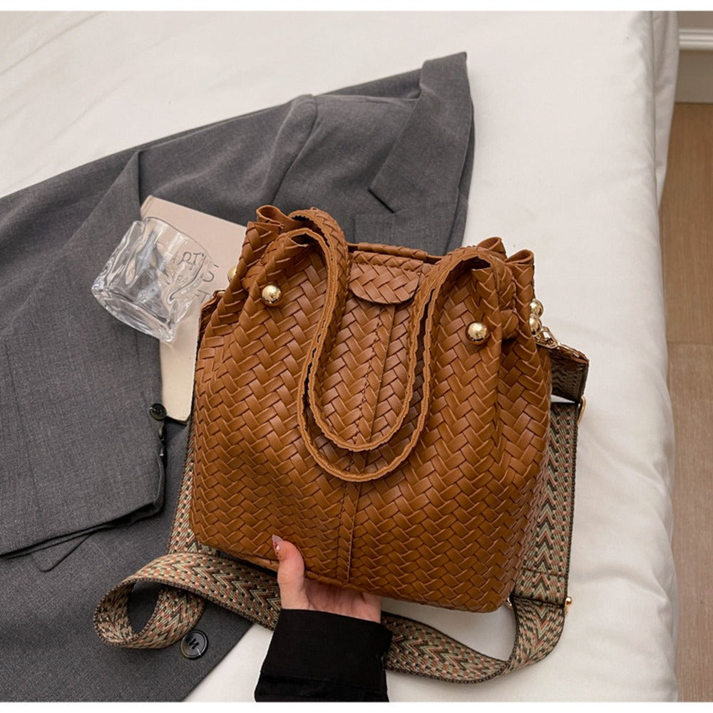 Woven Caramel bucket bag with top handles and wide crossbody strap